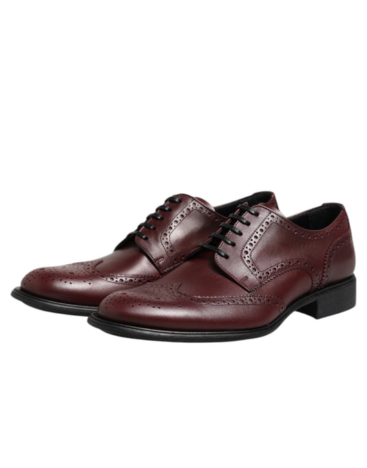Pair of brown leather lace-up dress shoes with a shiny finish, featuring a classic derby design