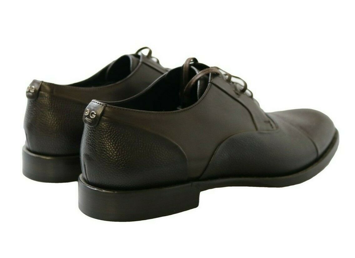 Pair of black leather shoes with laces and a small heel
