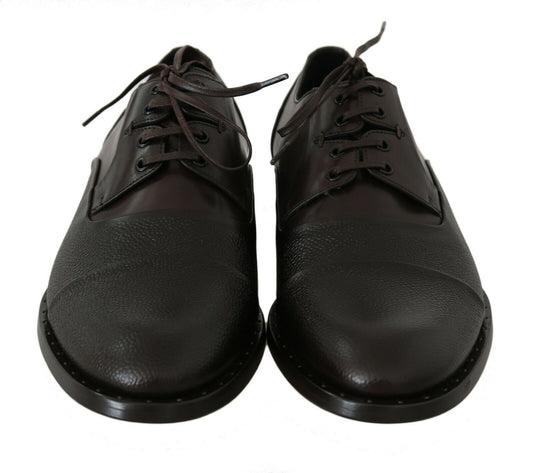 Pair of brown leather shoes with laces and a strap across the top