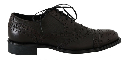 Pair of brown leather shoes with laces and a small heel