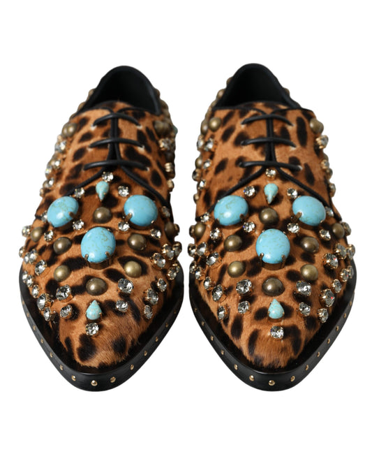 Pair of boots with turquoise stones and gold beads on a leopard print background