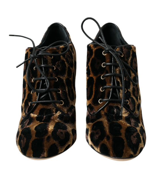 Pair of women's boots with a leopard print pattern and black laces
