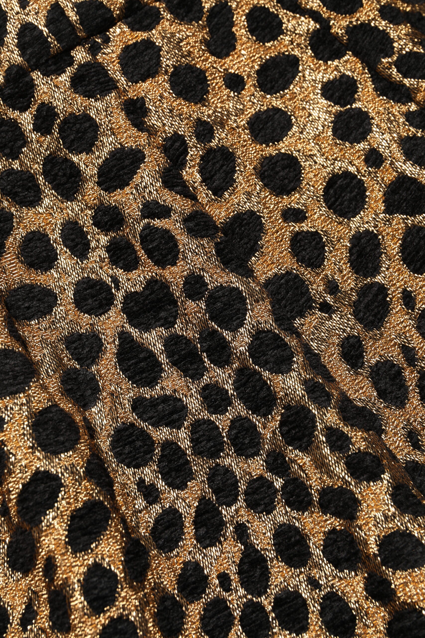 Leopard print fabric with gold dots