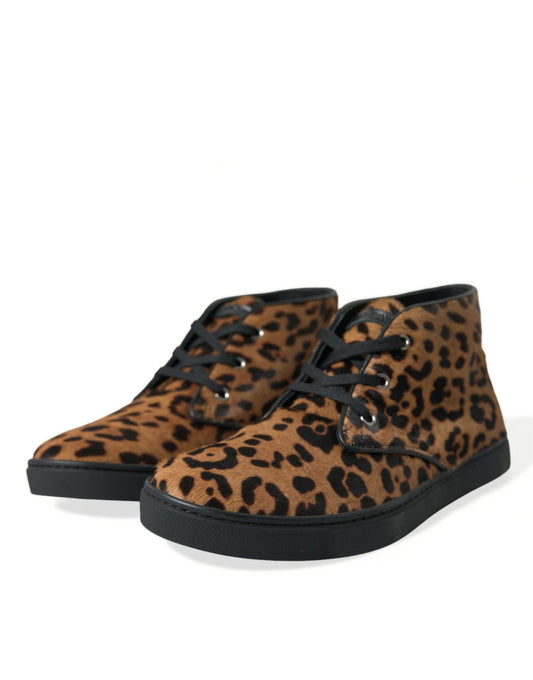 Pair of brown and black leopard print boots with laces