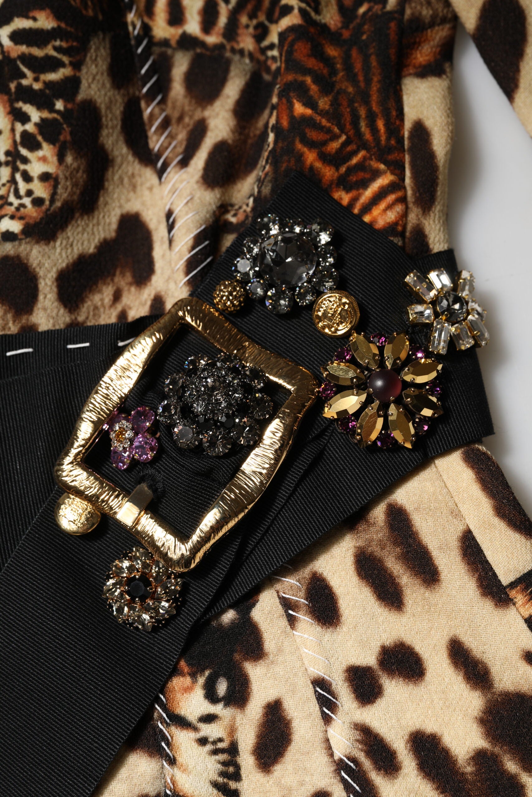 Gold belt with large buckle and multiple decorative elements on a brown leopard print dress