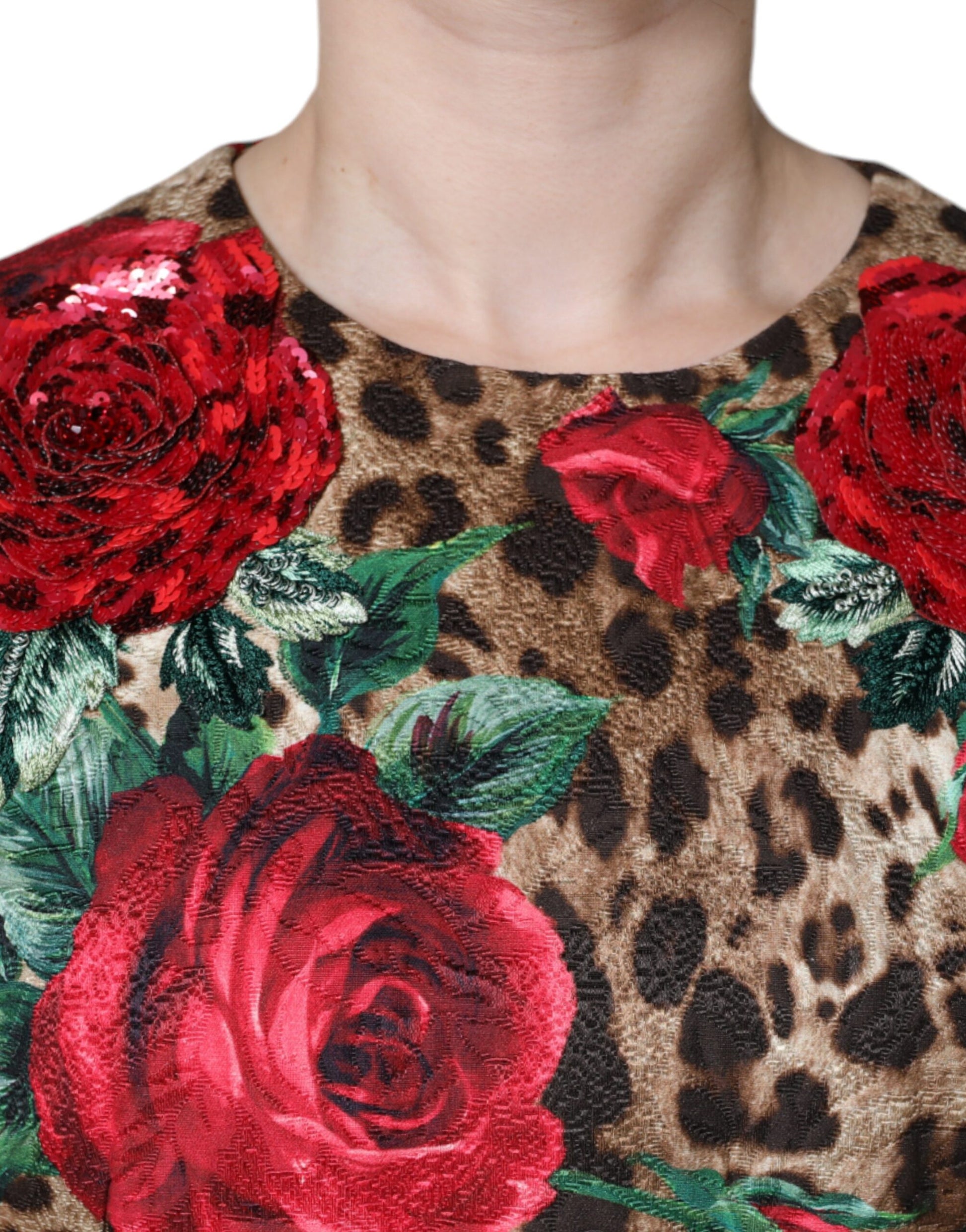 A dress with a brown leopard print background and red roses as the central design