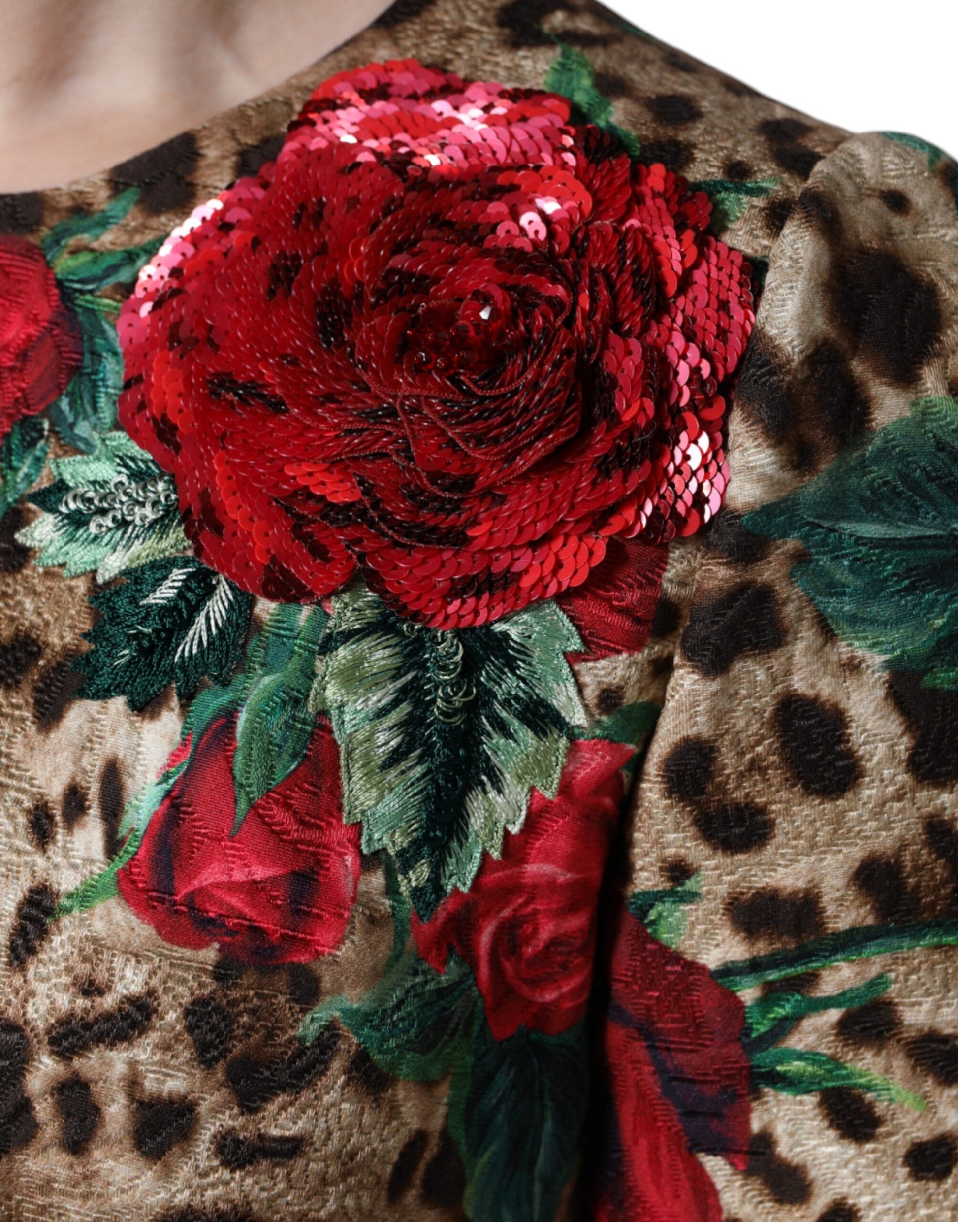 A dress with a brown leopard print and red roses embroidered on the front