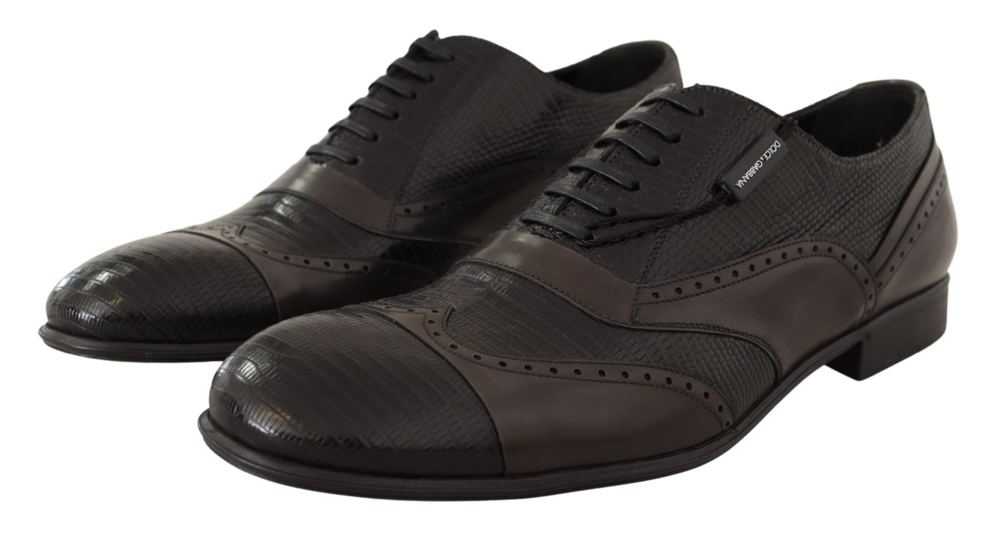 Pair of black dress shoes with laces and a small heel