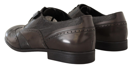 Pair of brown leather shoes with laces and a small heel