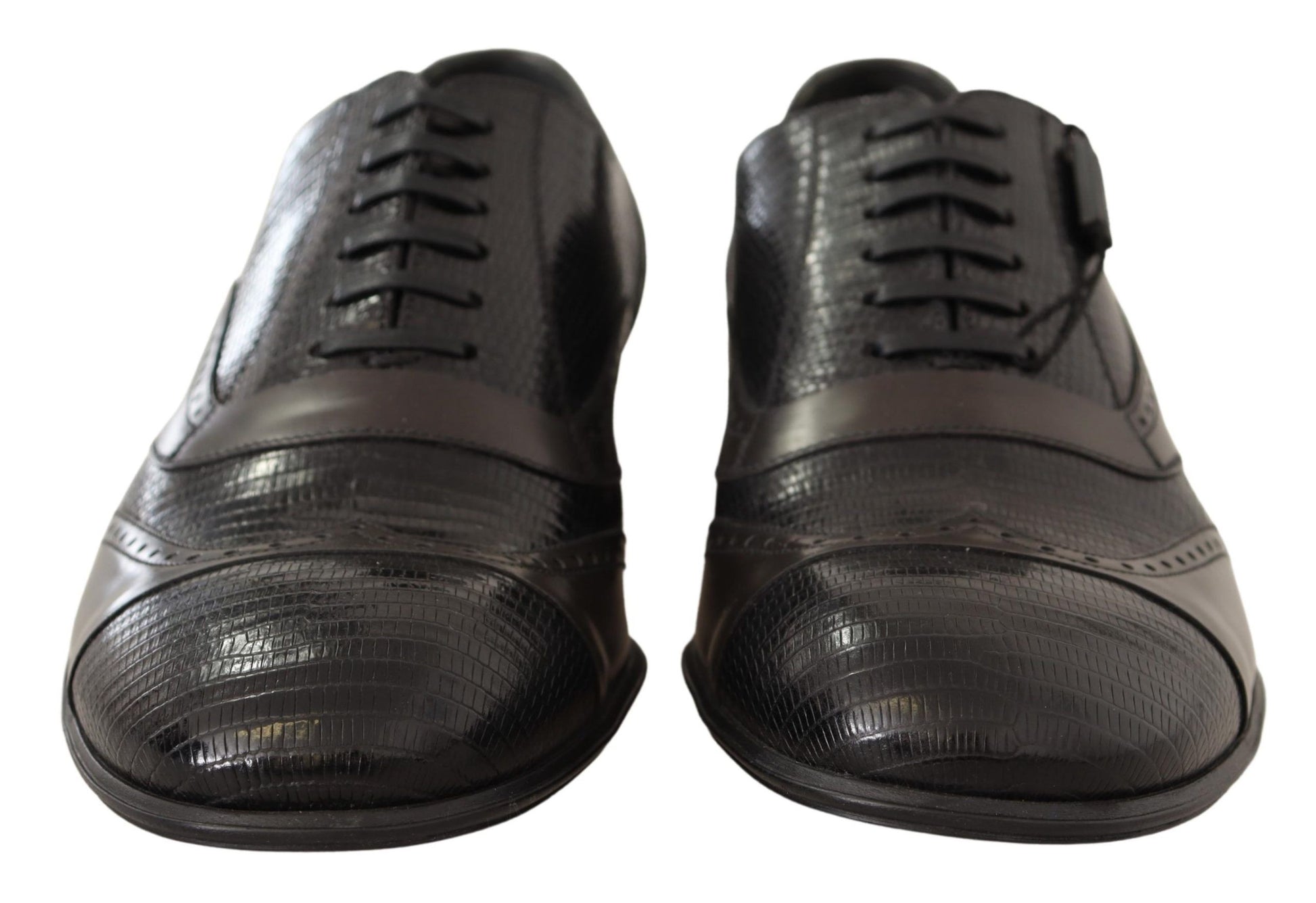 Pair of black leather shoes with laces and a shiny finish
