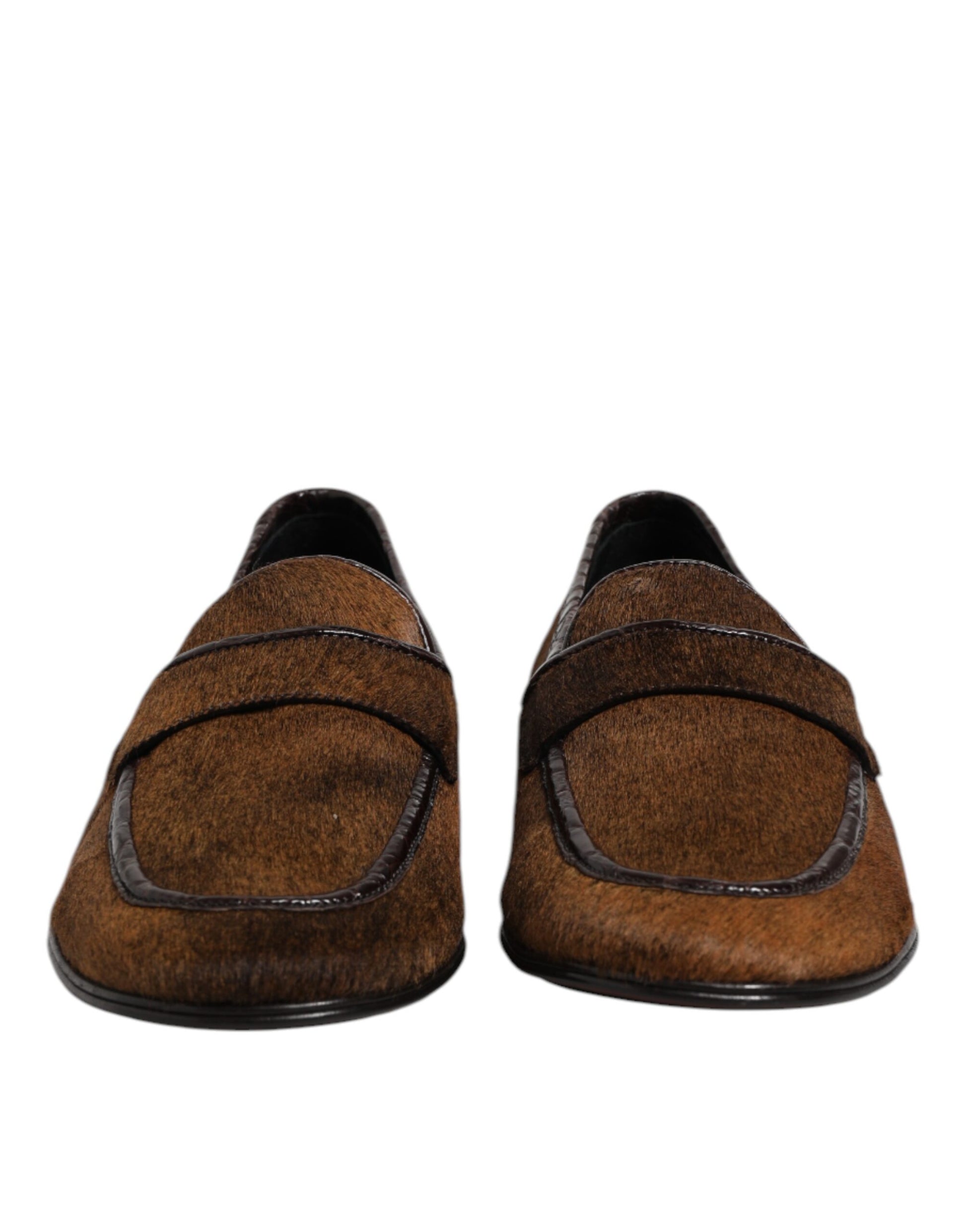 Pair of brown loafers with black soles, leather material, and elastic straps