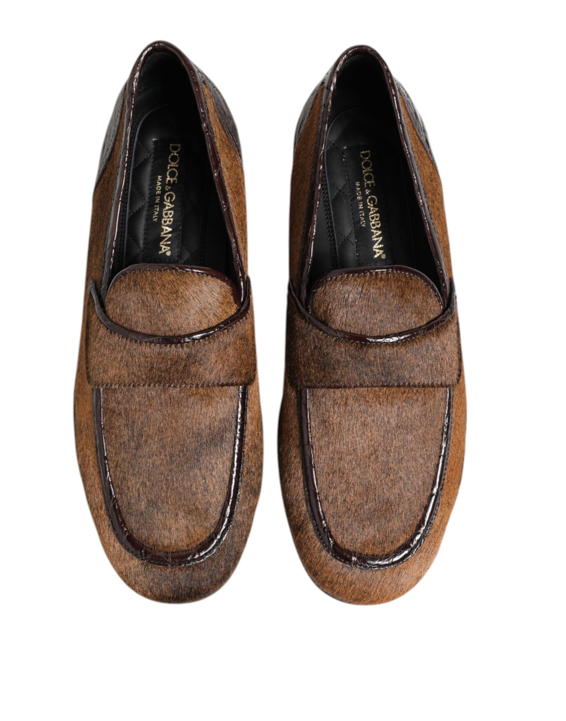Pair of brown loafers with black trim, featuring a logo on the side