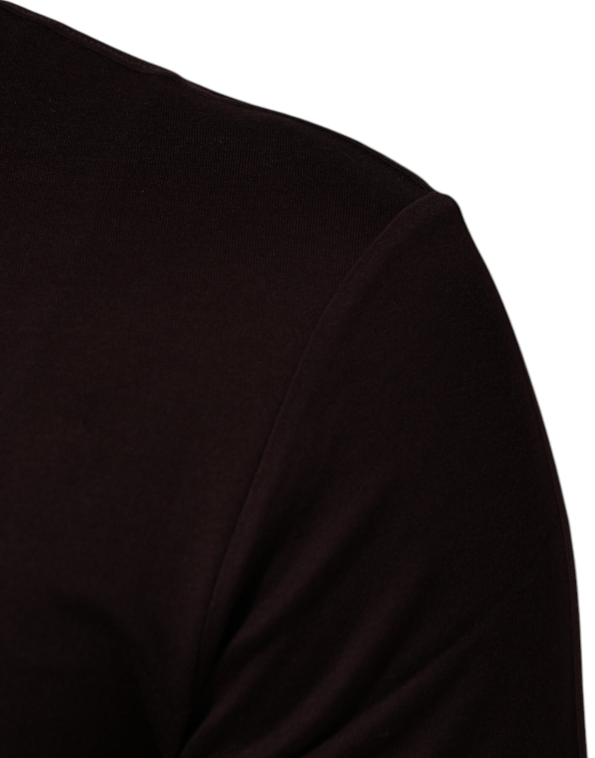 A person wearing a dark top or sweater
