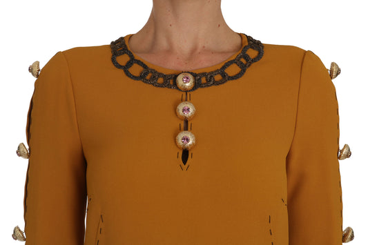 A brown dress with a crystal embellished neckline and sleeves