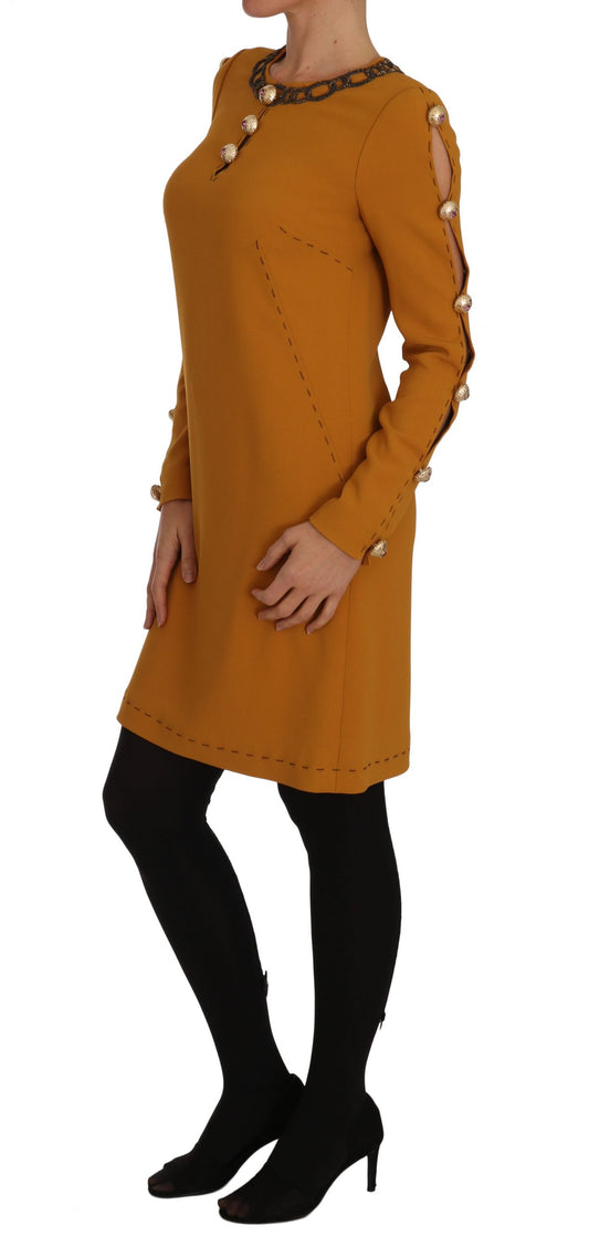 A brown dress with crystal embellishments on a mannequin