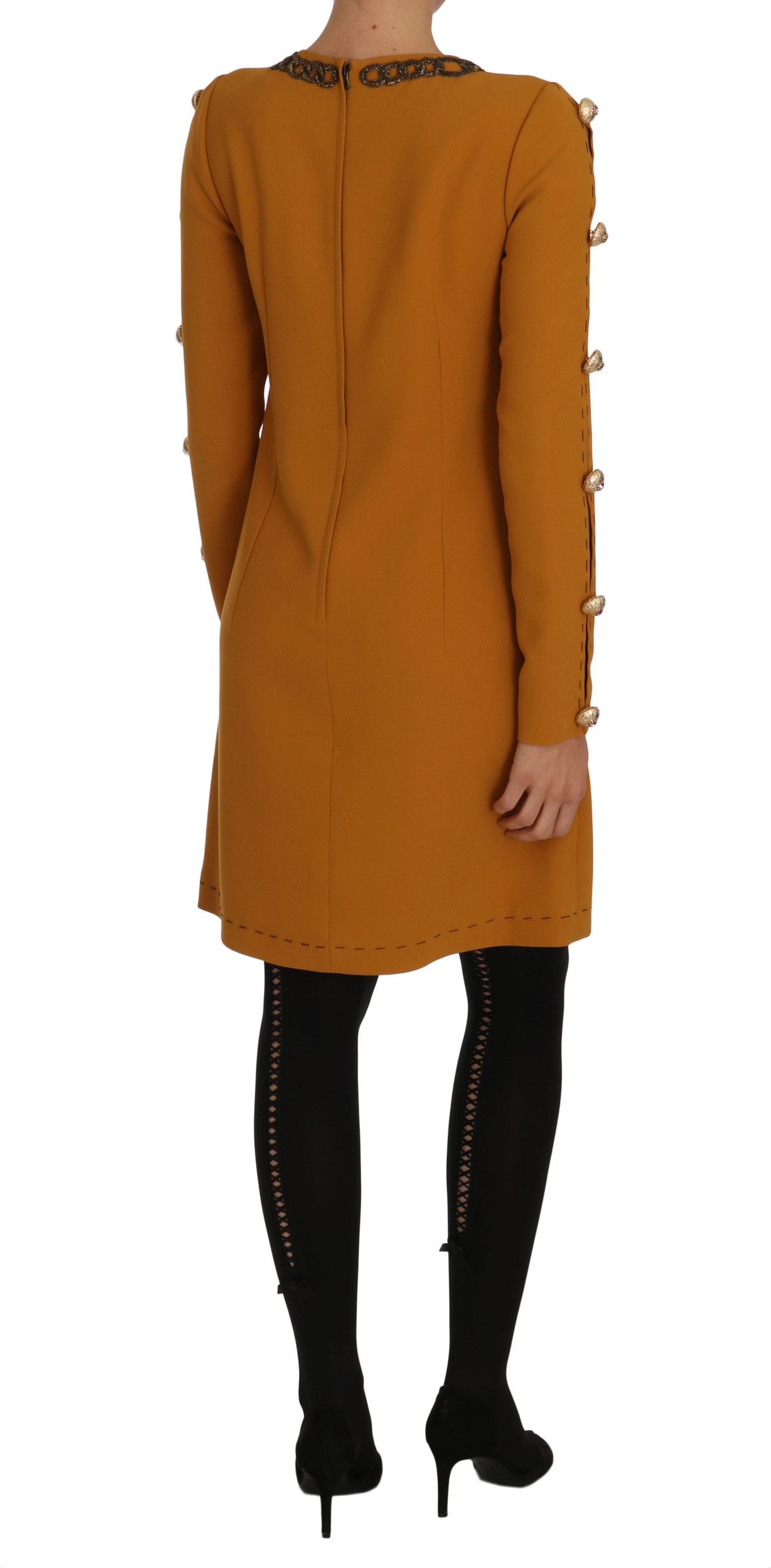 A long brown coat with crystal embellishments and a high neckline