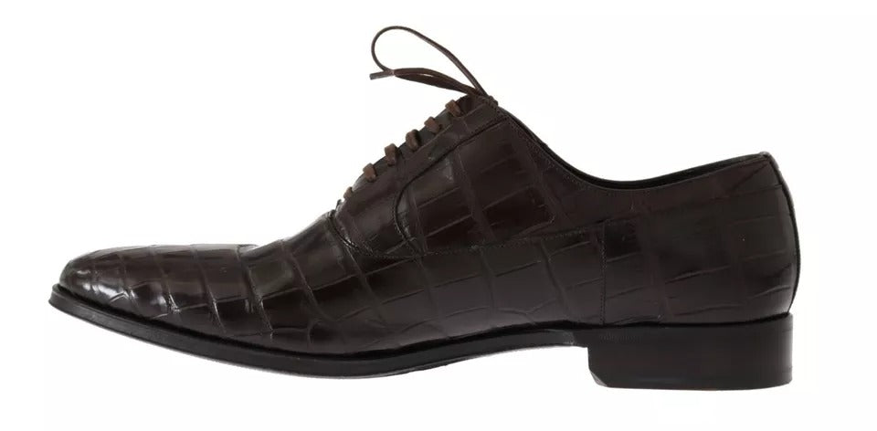 A pair of brown patterned leather dress shoes with laces and a low heel, designed by Dolce & Gabbana