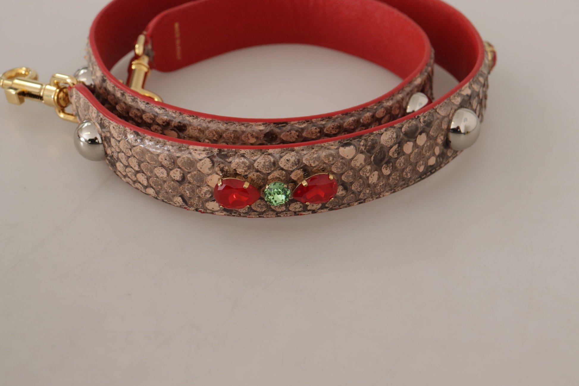 Two bracelets on a table. One is red and brown, the other is red and gold
