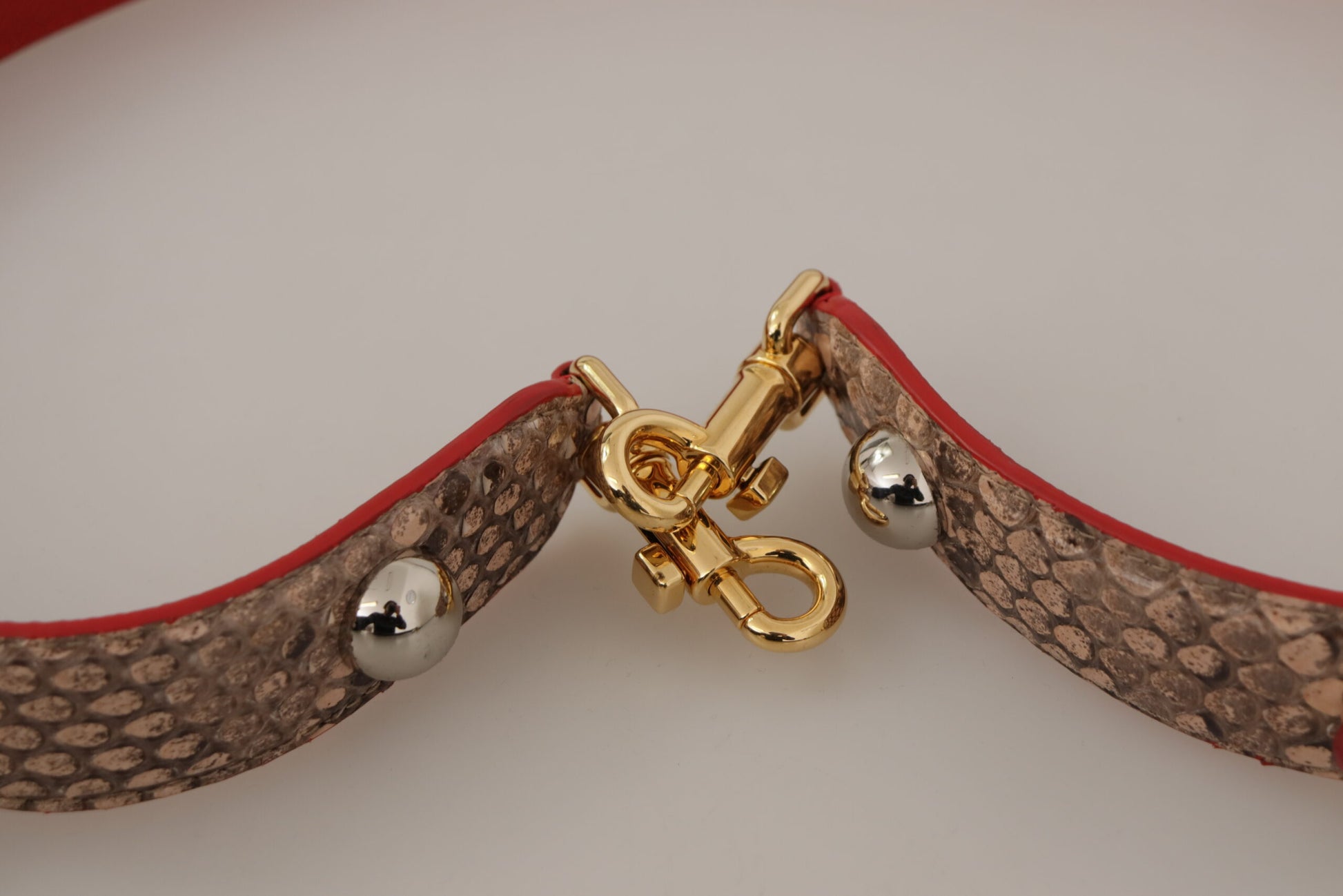 Gold buckle on red leather belt
