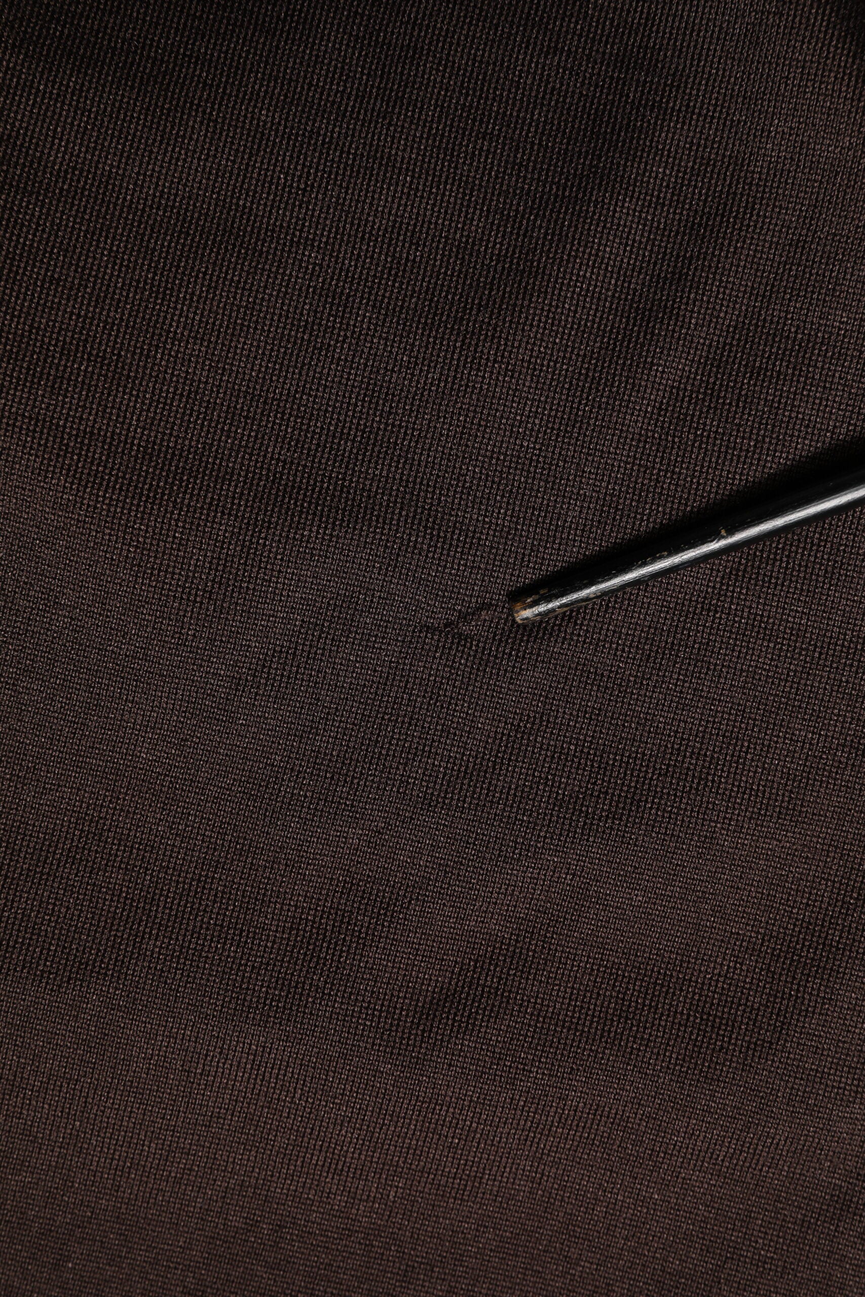 Small black pin on fabric