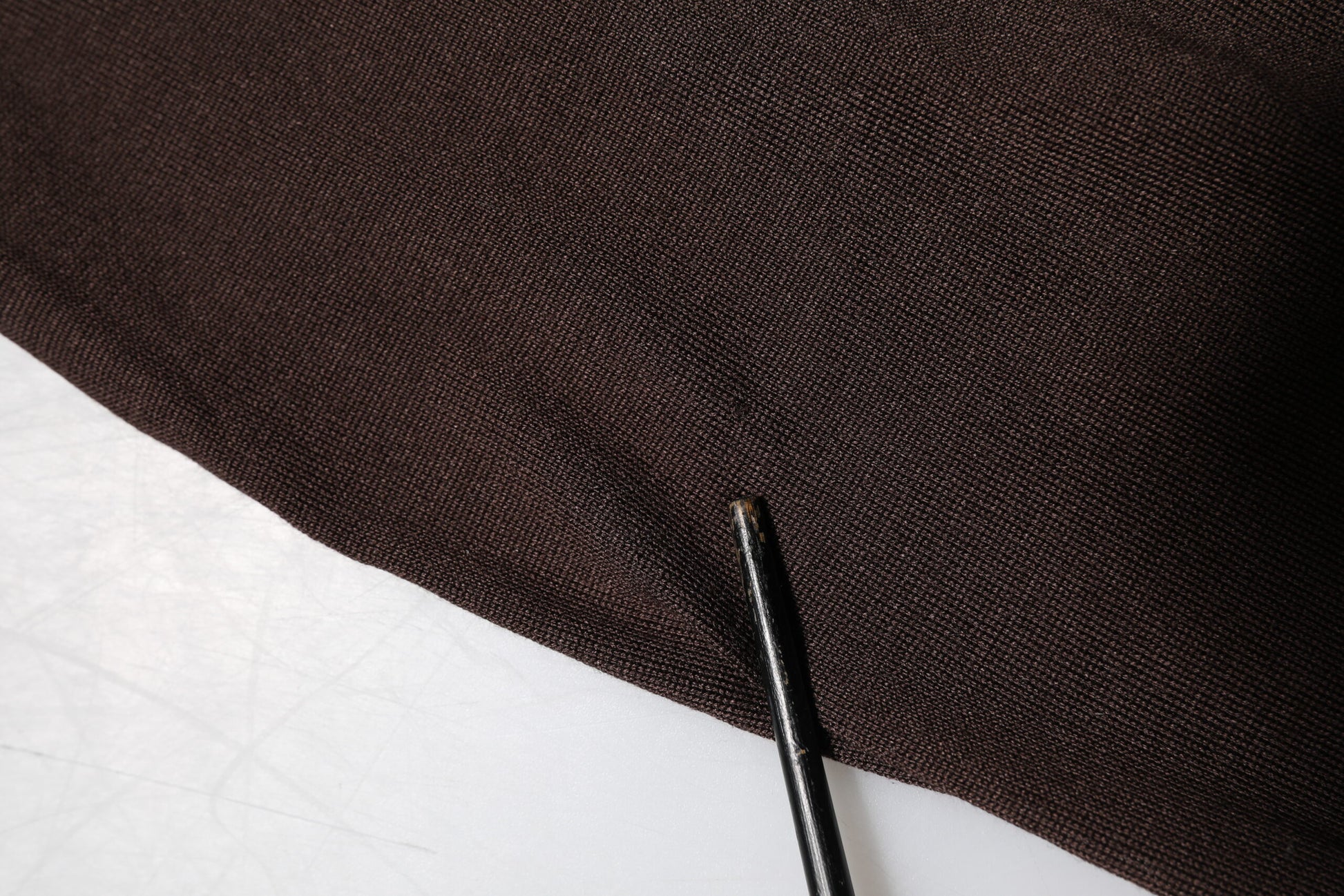 Black fabric with a small hole in it