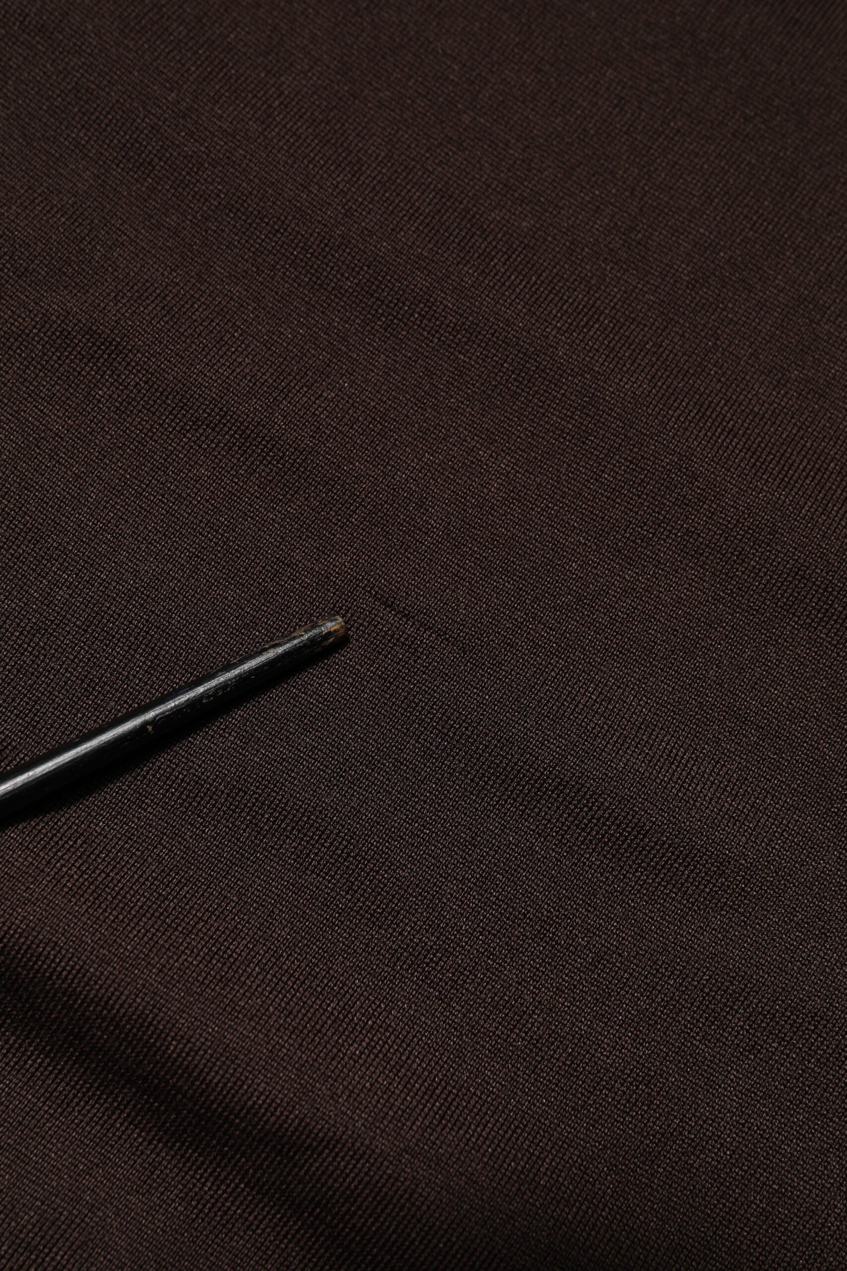 Black fabric with a small black object on top
