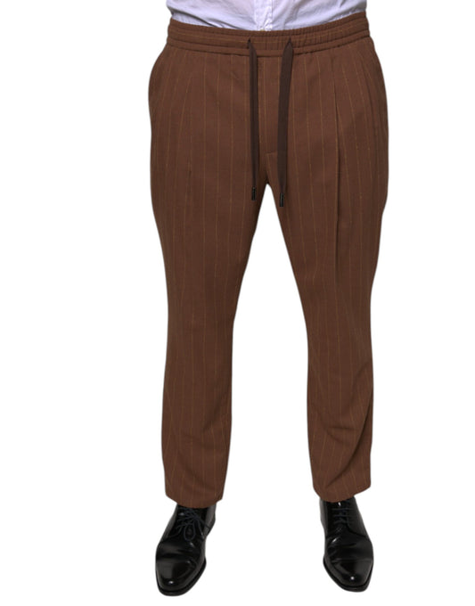 A pair of brown striped men's dress pants from the brand Dolce & Gabbana. They are designed with a skinny fit