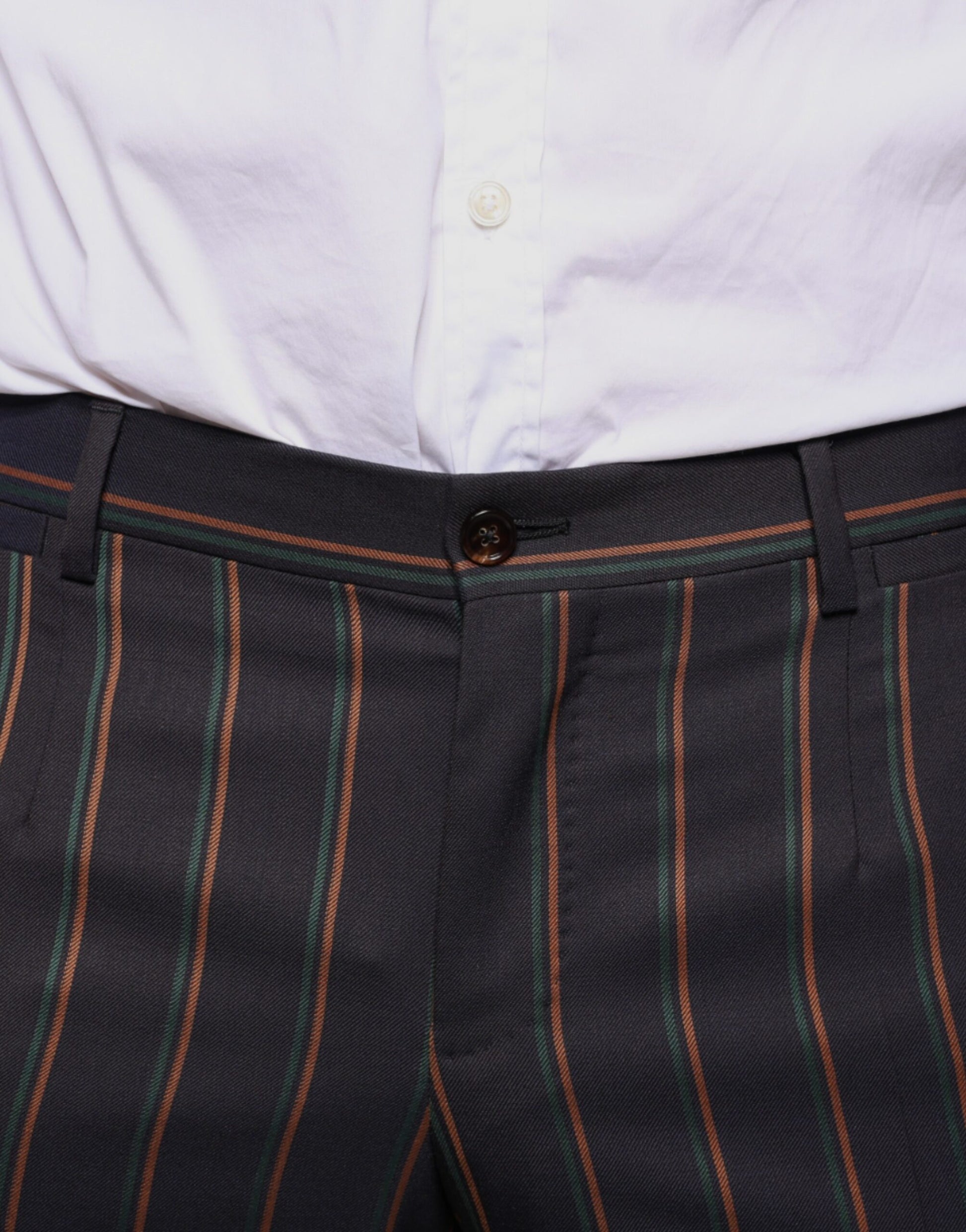 A pair of men's dress pants with brown stripes on the side. They are designed by Dolce & Gabbana and appear t