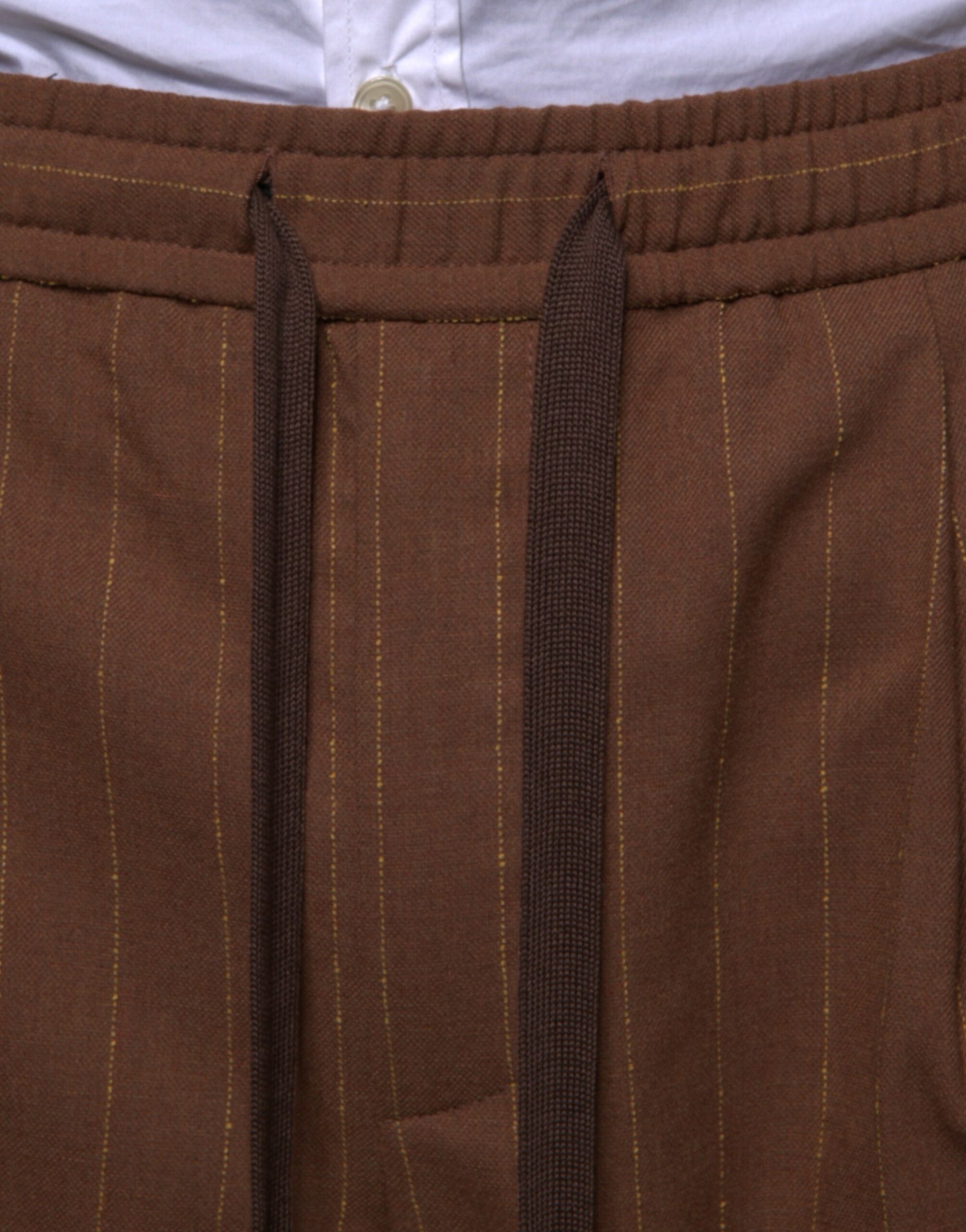 Brown striped men's dress pants with a skinny fit, featuring a button and zipper closure