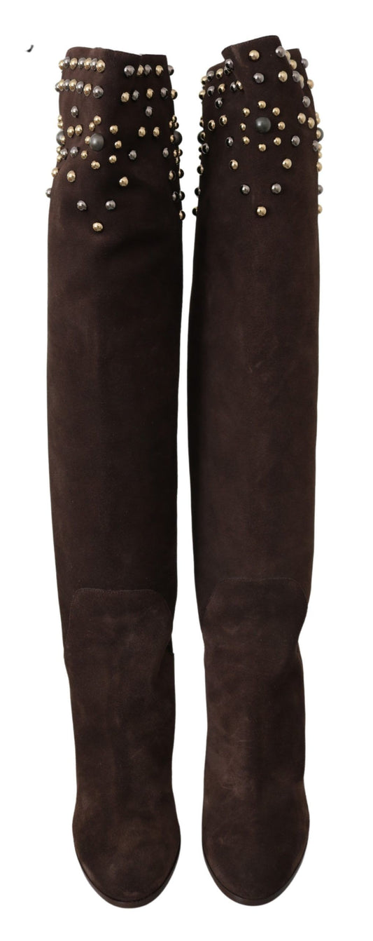 Two brown knee high boots with spiky studs on top