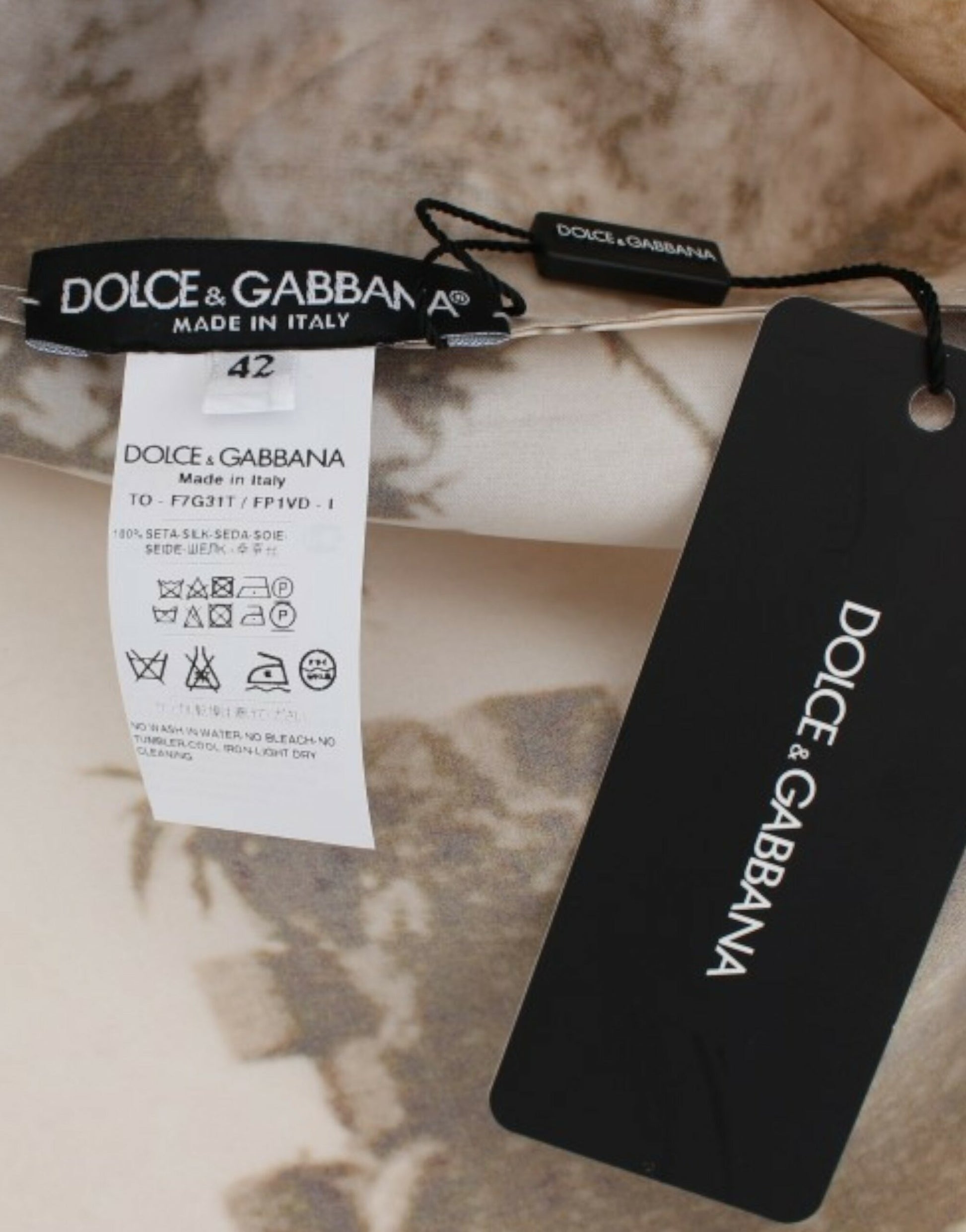 Black tag on a bedspread with white writing