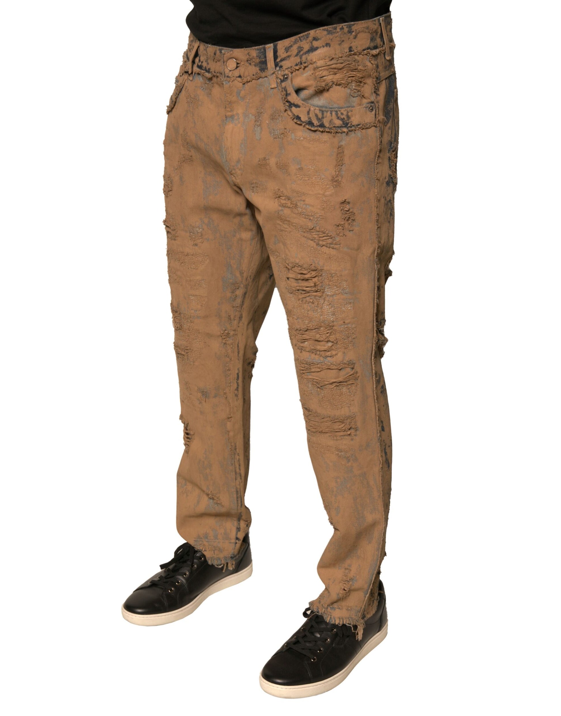 Pair of distressed jeans worn by a person