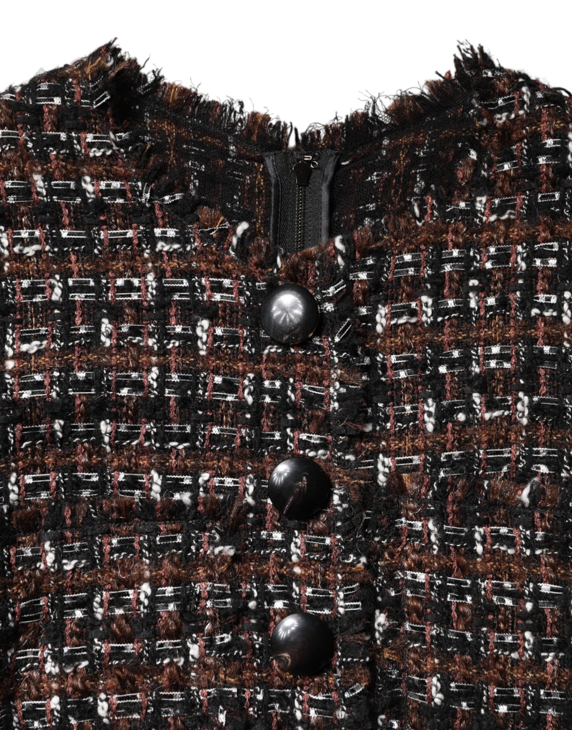 A close-up view of a garment that appears to be a jacket or coat. It is adorned with numerous buttons and wha