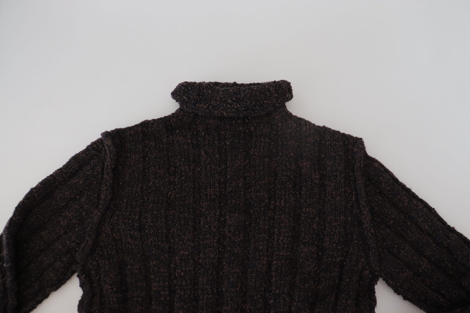 Dark knit sweater on white surface