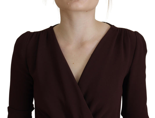 A woman wearing a brown wrap long sleeve midi stretch dress by Dolce & Gabbana