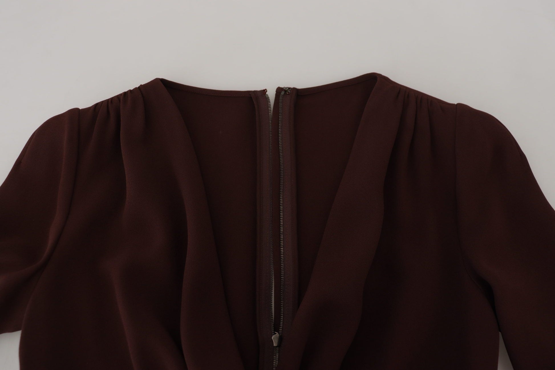 A brown midi dress with long sleeves and a wrap style, featuring stretch material