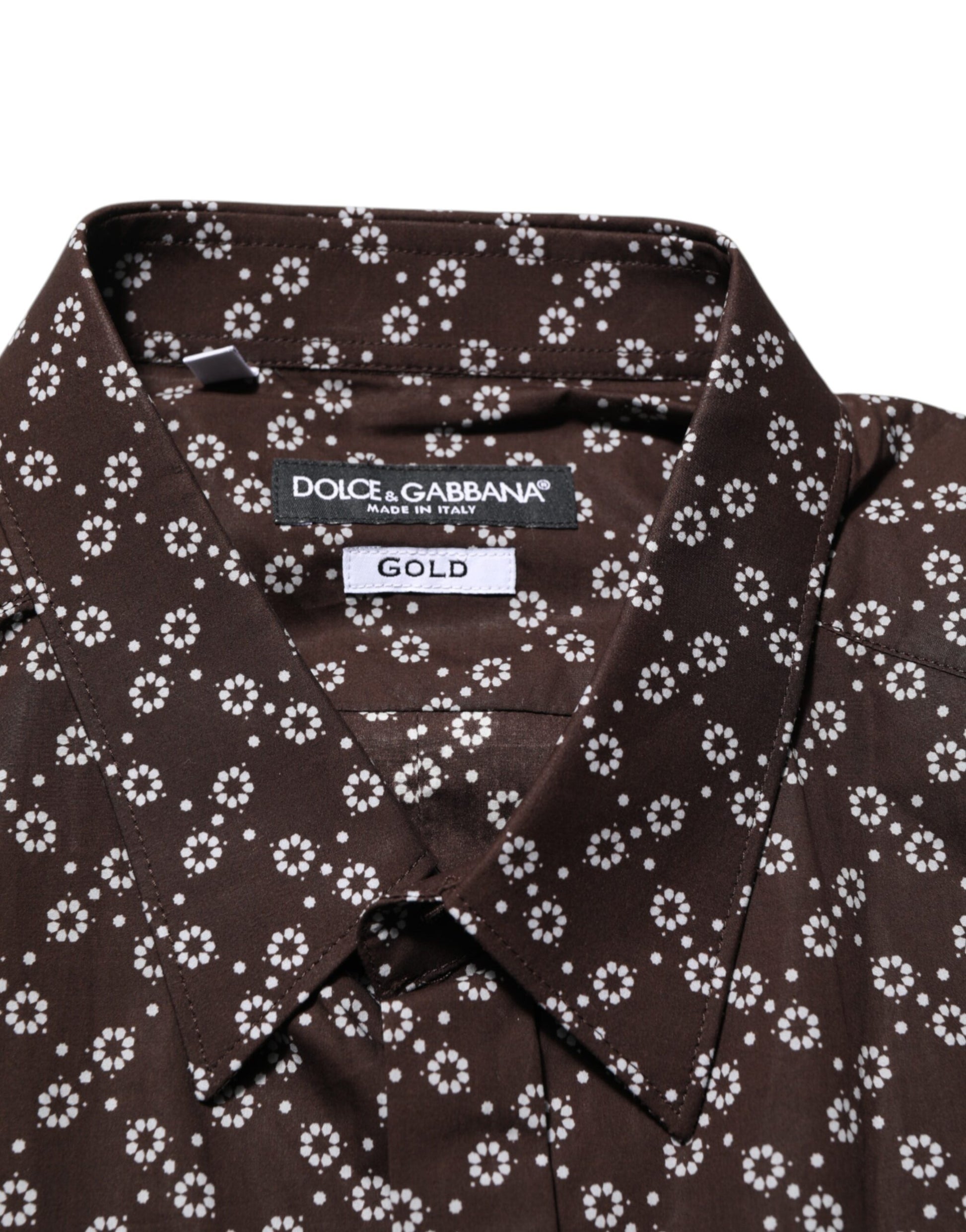 A brown floral collared shirt with a gold label on the front