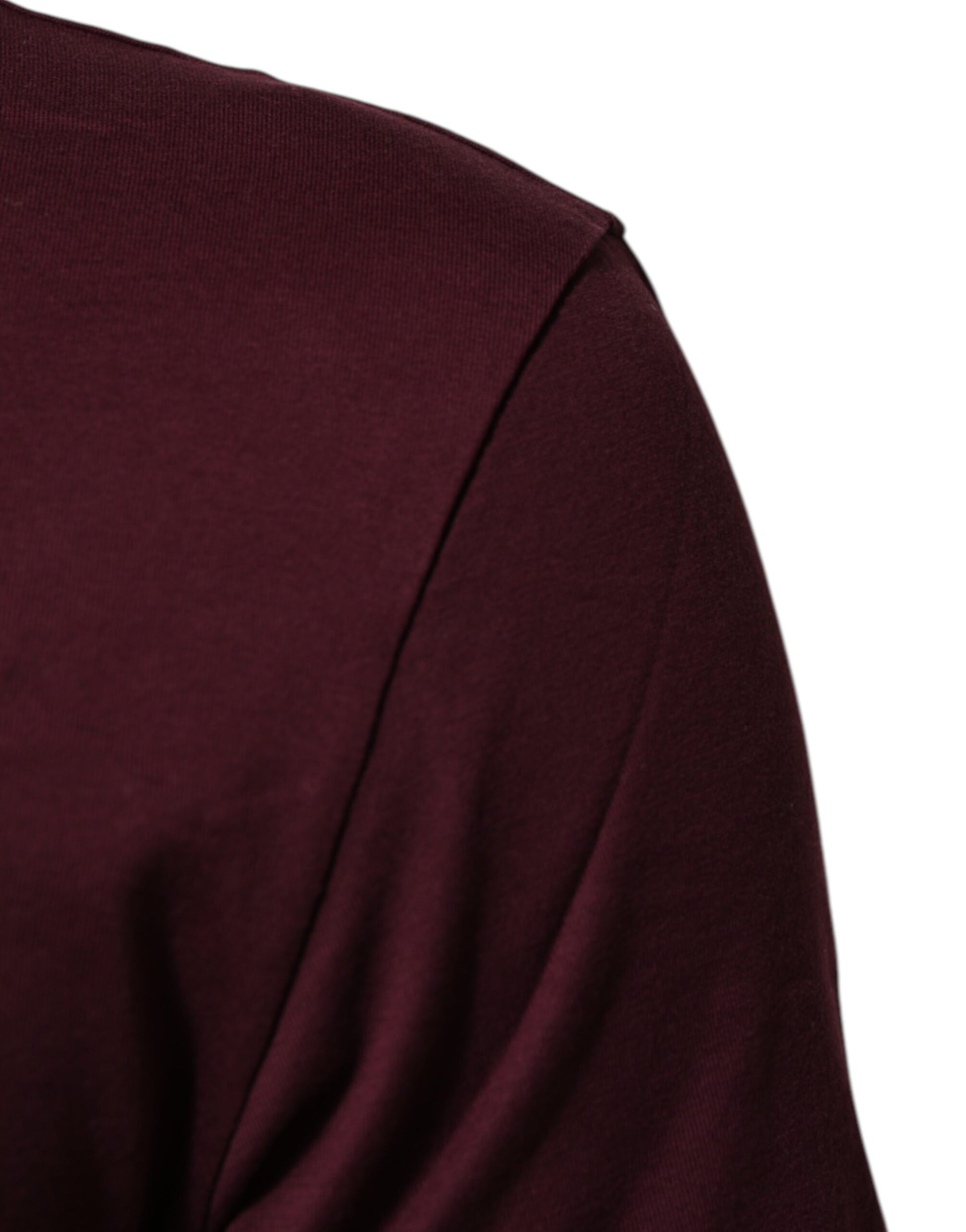 A person wearing a dark red long sleeve shirt