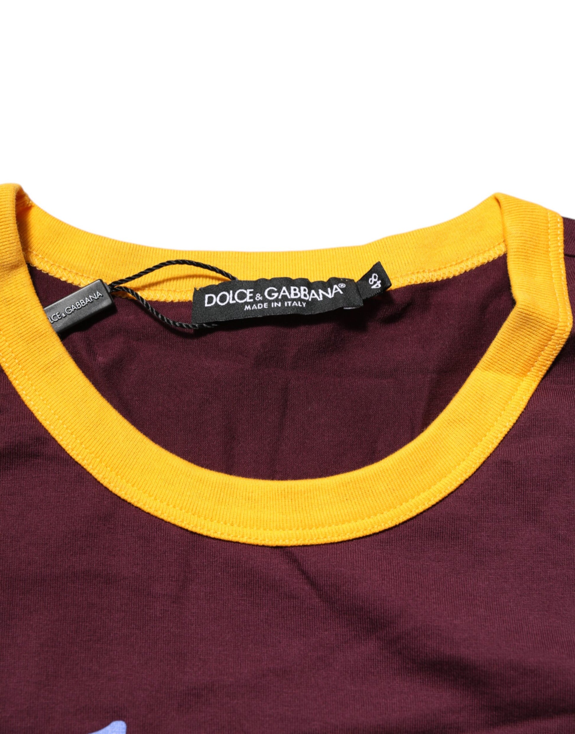 Maroon shirt with yellow trim on hoodie
