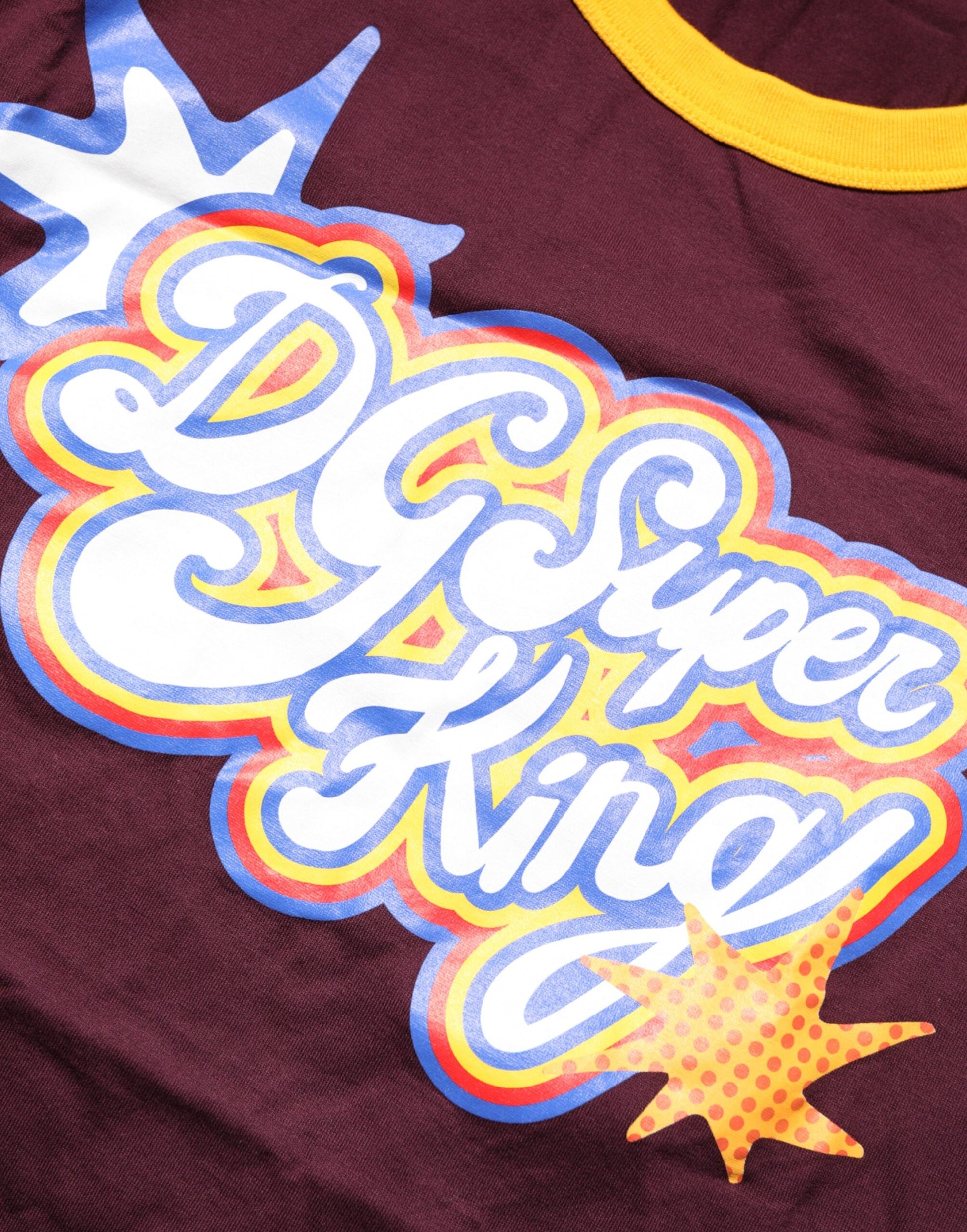Maroon shirt with yellow and blue graphic design