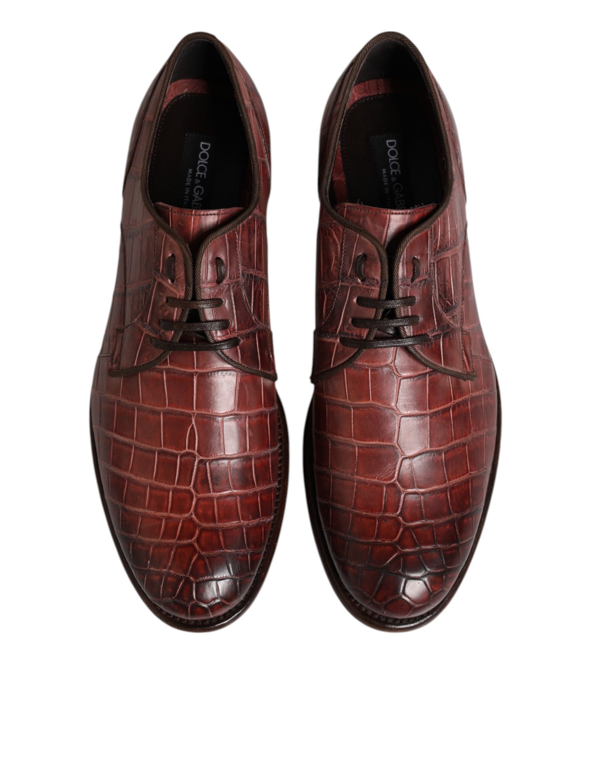 Pair of burgundy leather lace-up dress shoes with a crocodile skin texture