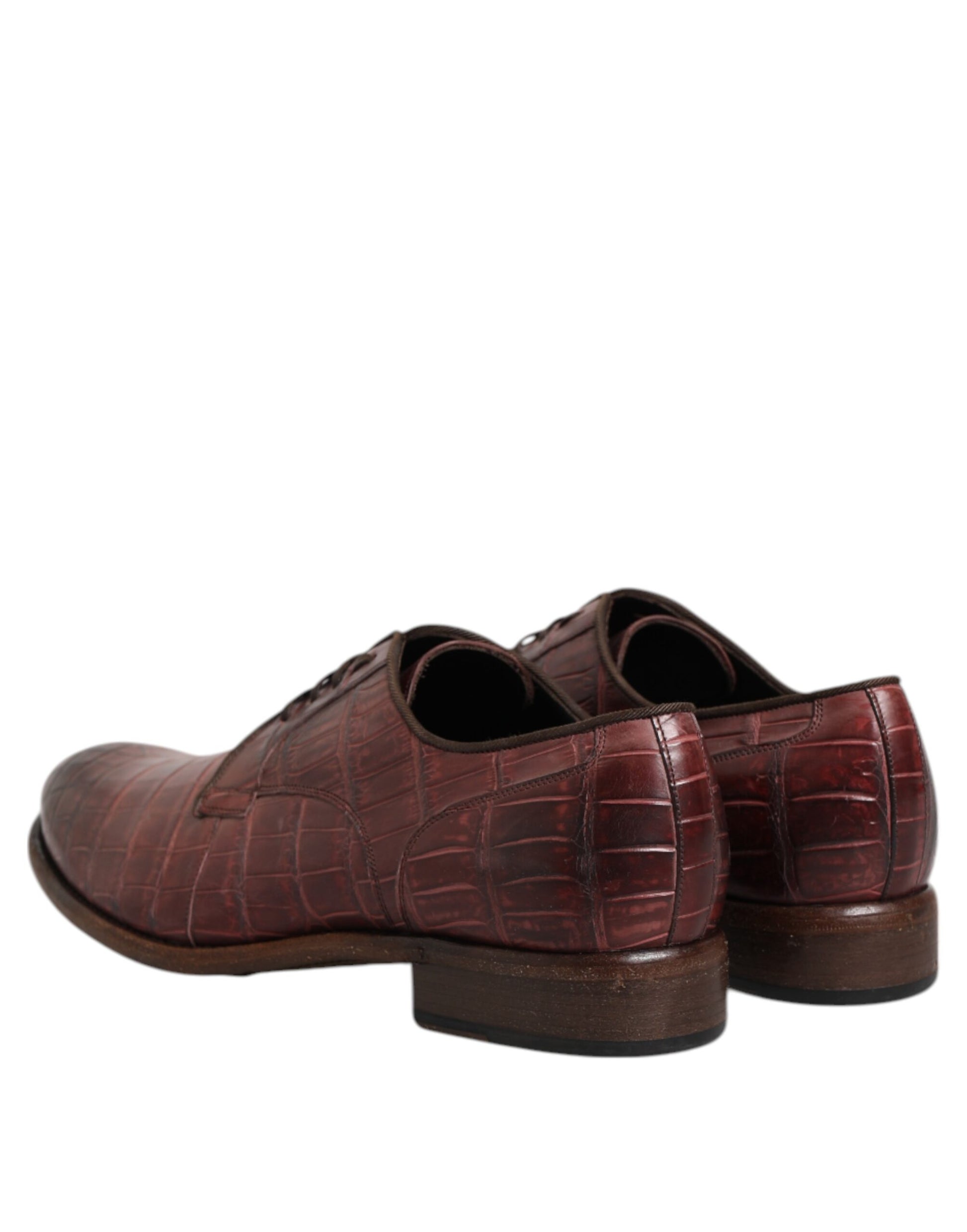 Pair of burgundy leather lace-up dress shoes with a crocodile skin texture