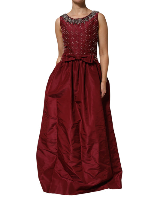 A long burgundy silk evening gown with beaded detailing and a fitted bodice