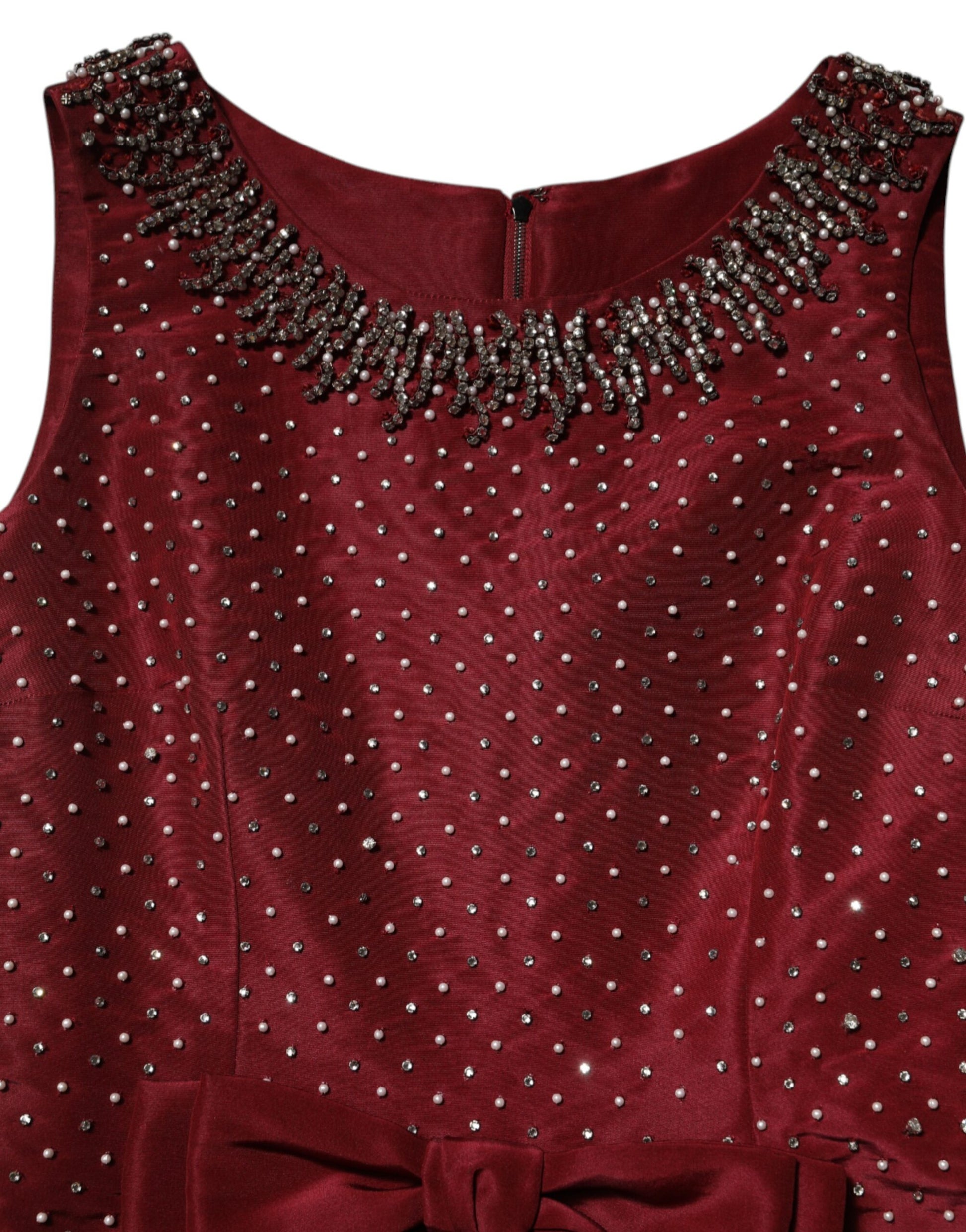 A red evening gown with beaded neckline and waistband