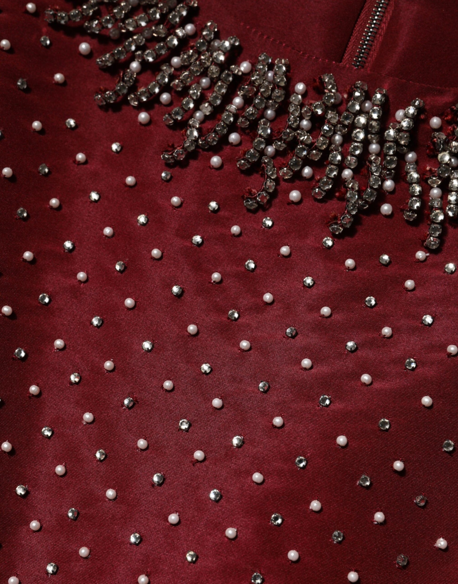 A burgundy silk evening gown with beaded embellishments