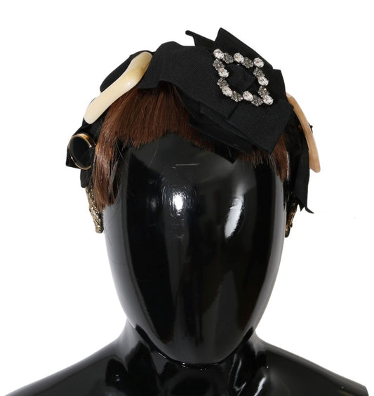 Headless mannequin wearing a black hat with rhinestones and feathers