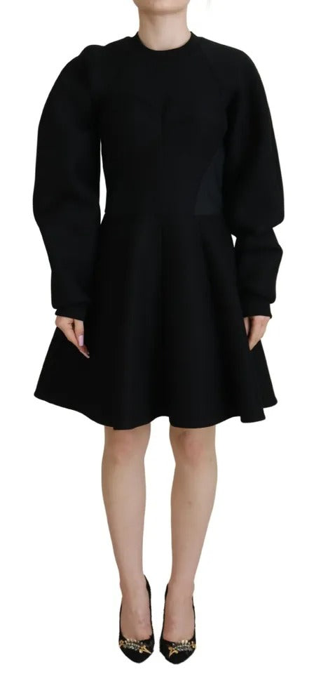 A black long sleeve dress with an A-line silhouette. It features a high neck and is made of cotton fabric