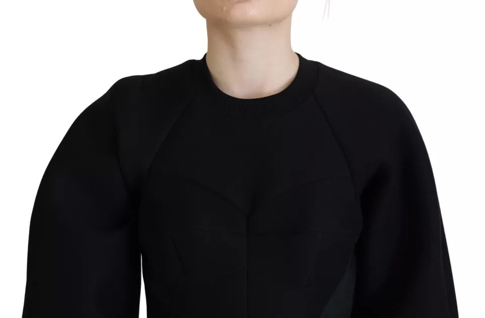 A black long sleeve dress with a V-neck. It appears to be made of cotton and has an A-line silhouette