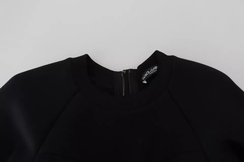 A black long sleeve dress with a V-neck and an A-line silhouette. It appears to be made of cotton, as indicat