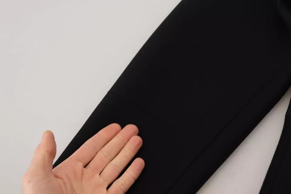 Hand touching black dress fabric